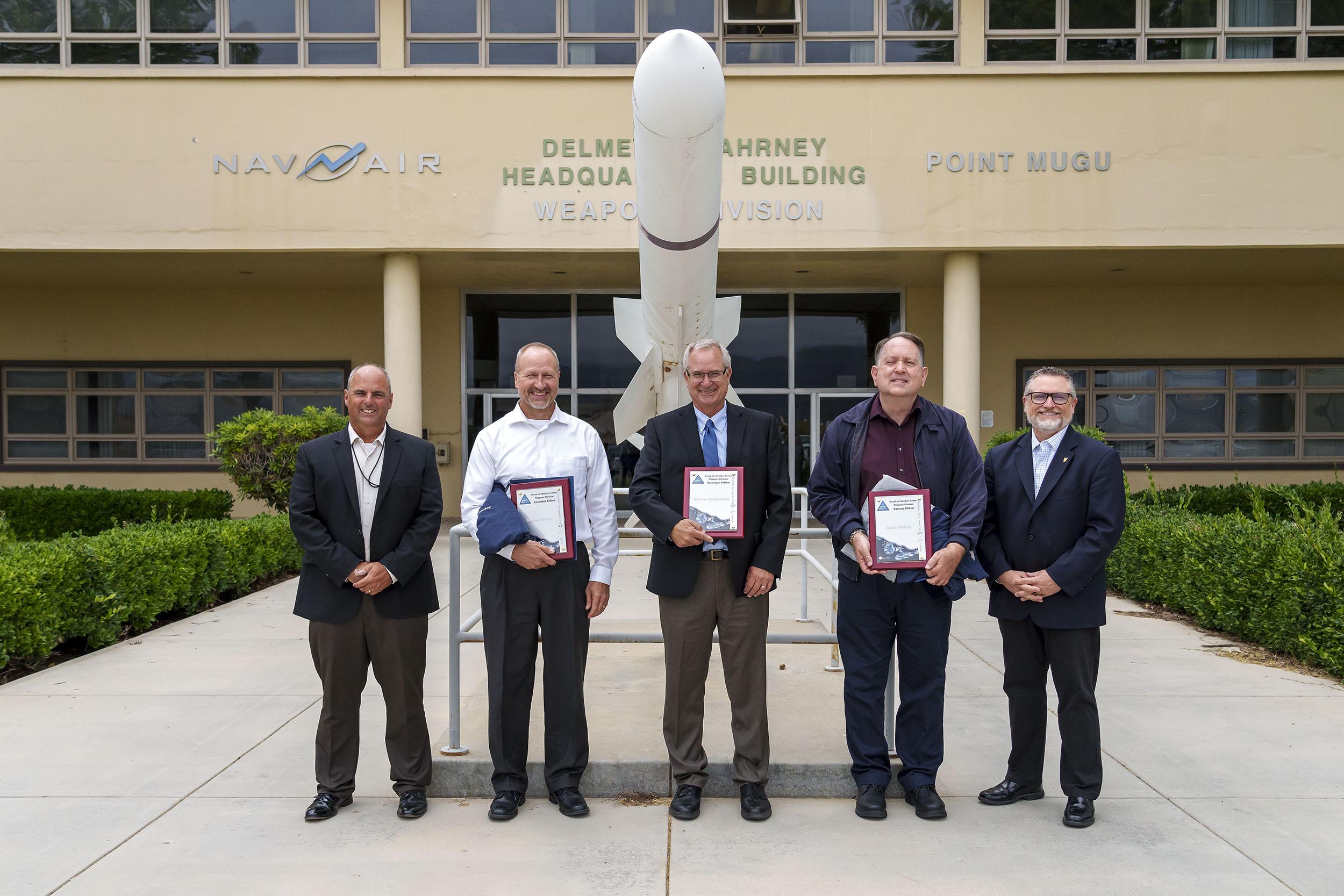 NAWCWD Fellow inductees from Point Mugu pose for a picture with Dan Carreño, NAWCWD executive director, left, and Tom Dowd, NAWCWD’s Ranges, Target Operations, Instrumentation and Labs Group director, right, after the Fellows induction ceremony on July 13. (U.S. Navy photo by Rob Grabendike)