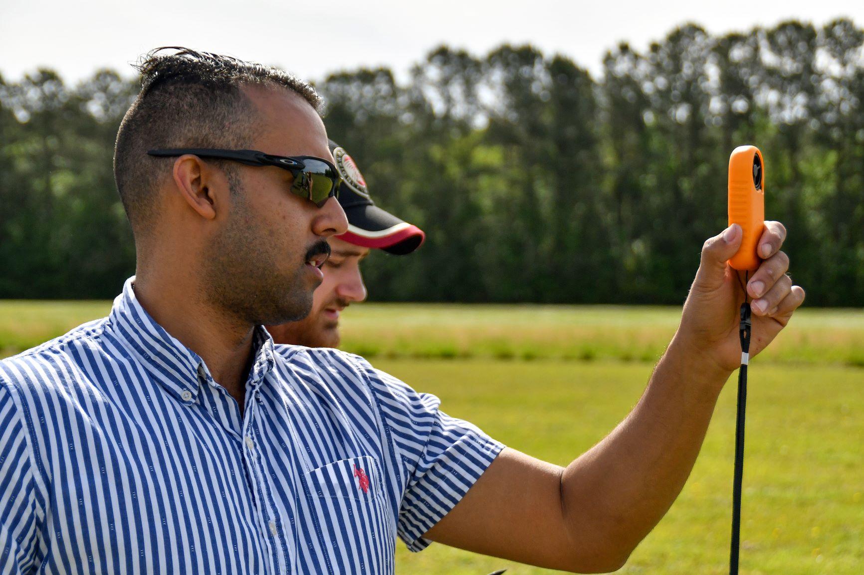 Chris Rivera, an engineer at Fleet Readiness Center East (FRCE), measures wind speed during the 2023 Ultimate Unmanned Aerial Vehicle Competition held April 22 in Newport. Students representing eastern North Carolina high schools designed unmanned aerial vehicles for the competition, which evaluated the speed and maneuverability of their creations.