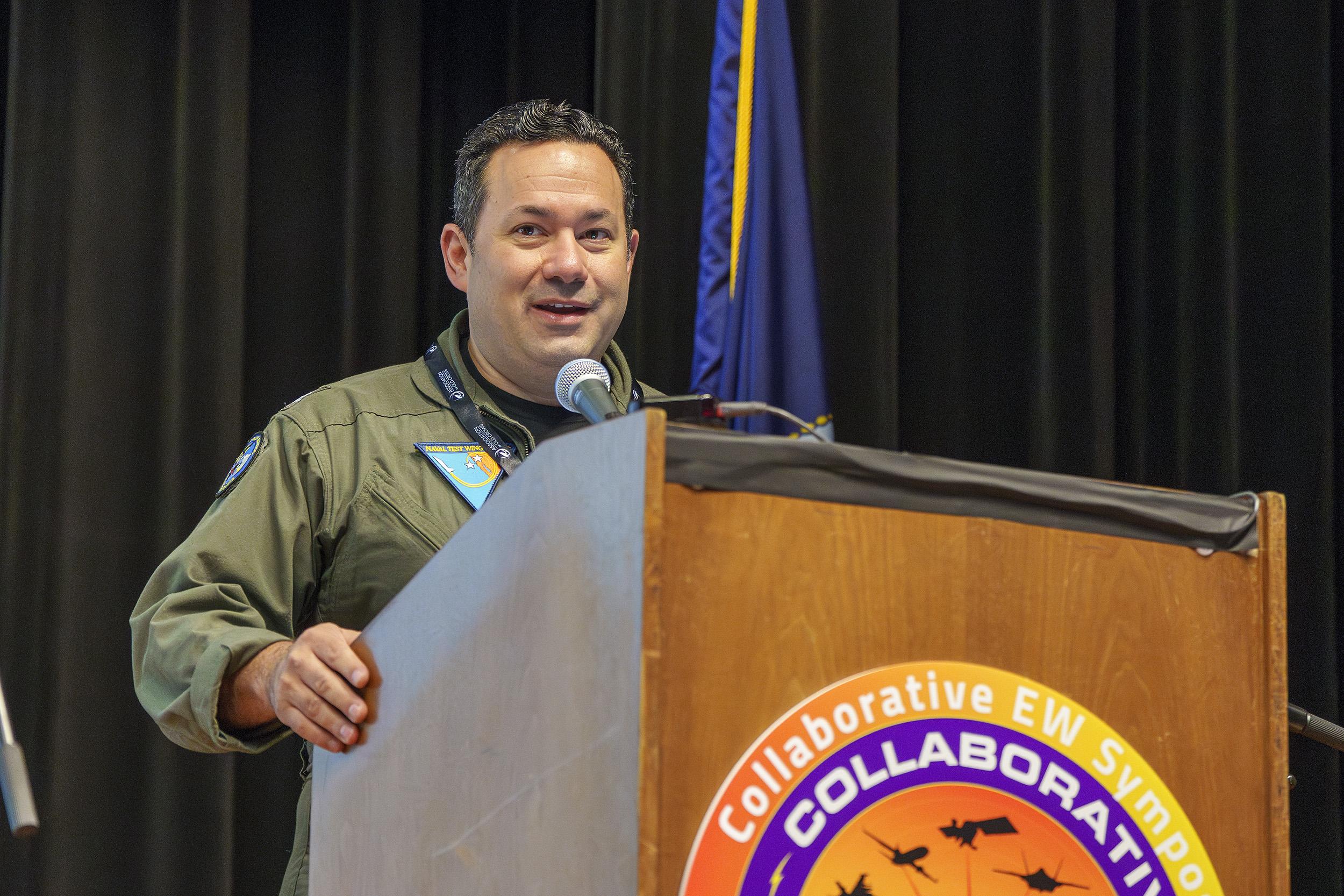 Capt. David Halpern, commodore, Naval Test Wing Pacific, delivers opening remarks during the Collaborative EW Symposium on March 12 in Point Mugu, California. (U.S. Navy photo by Rob Grabendike)