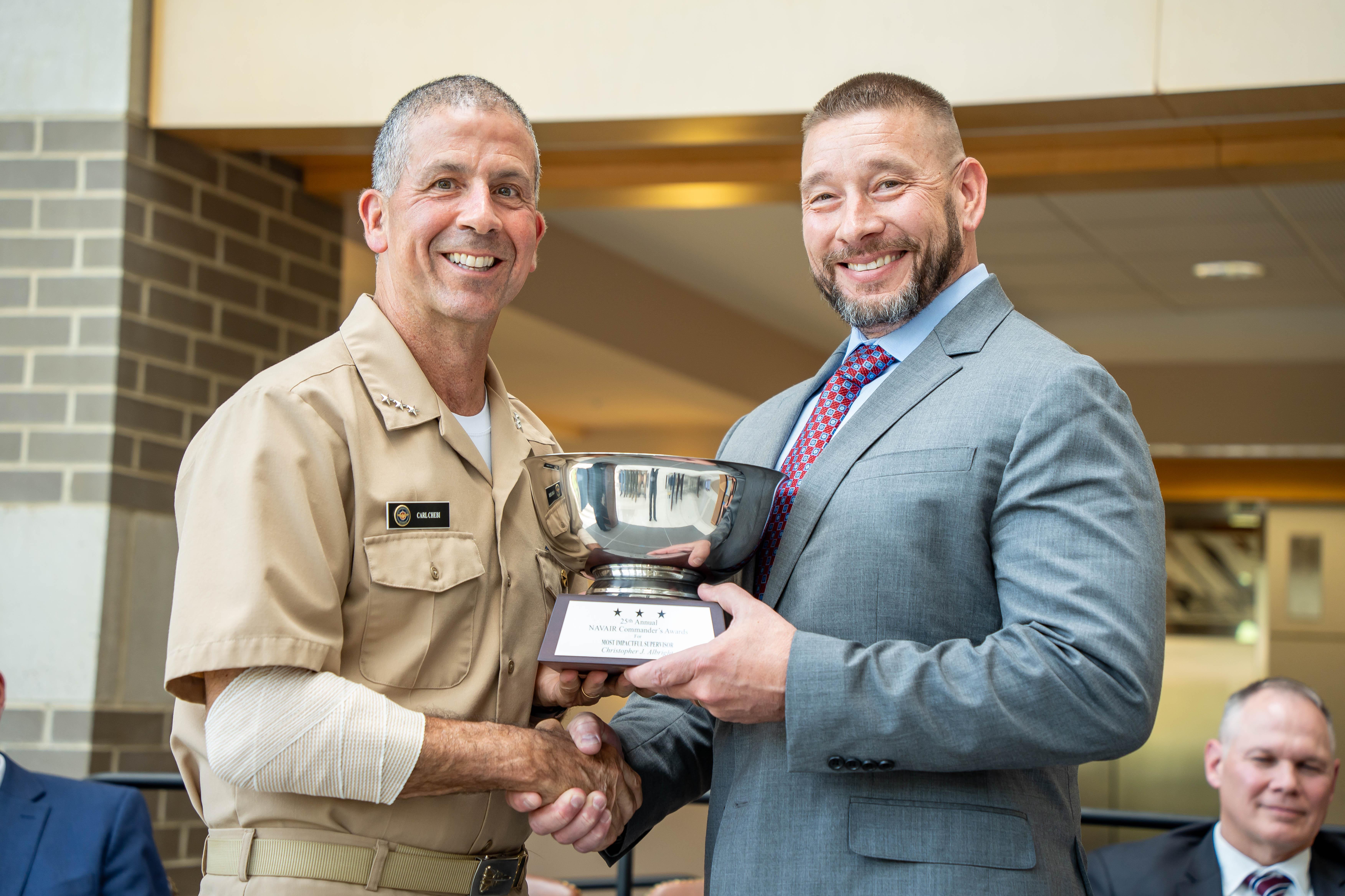 Vice Adm. Carl Chebi presents Chris Albright with the NAVAIR Commander’s Award for Most Impactful Supervisor