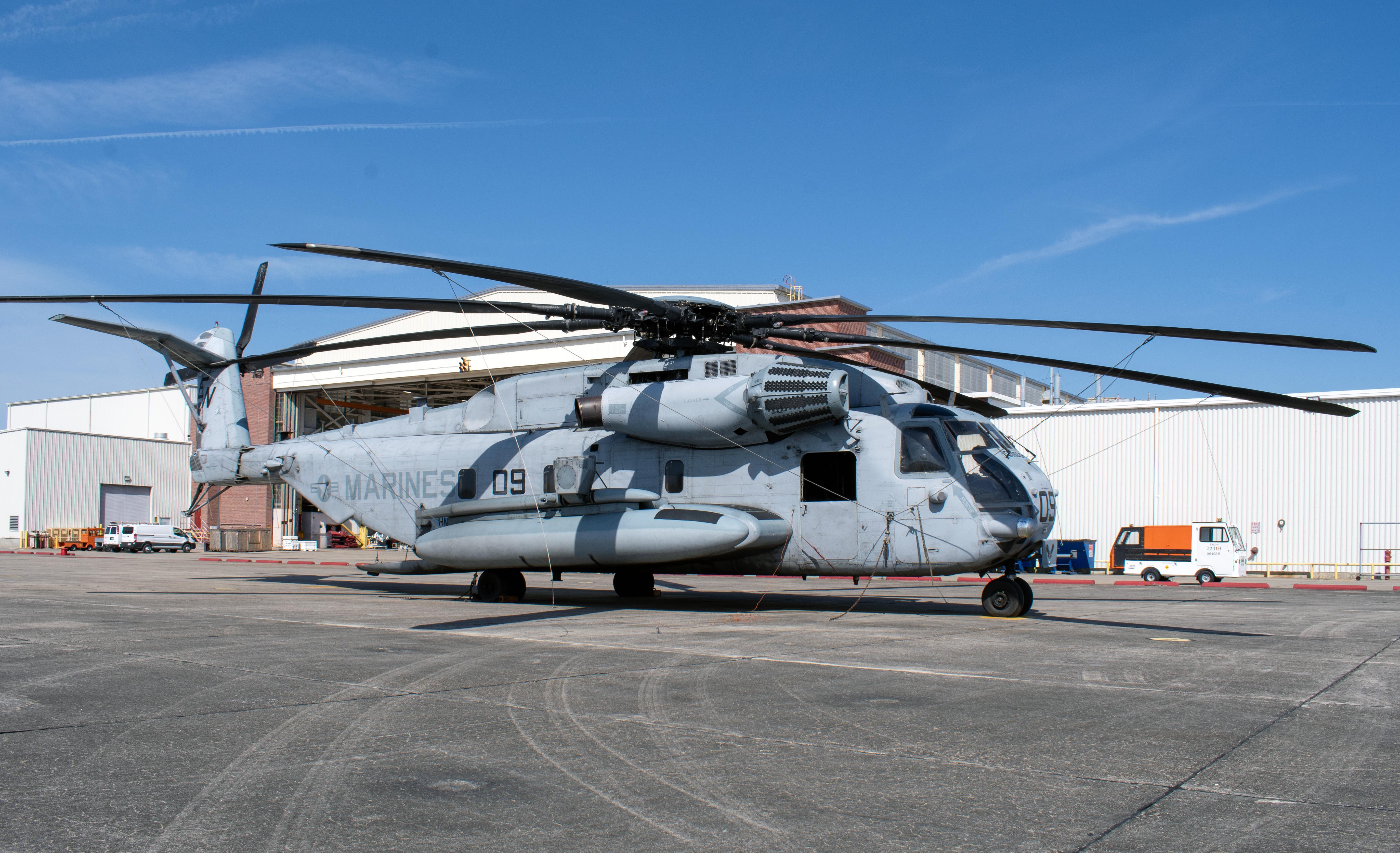 H-53 helicopter outside in front of an aircraft hangar
