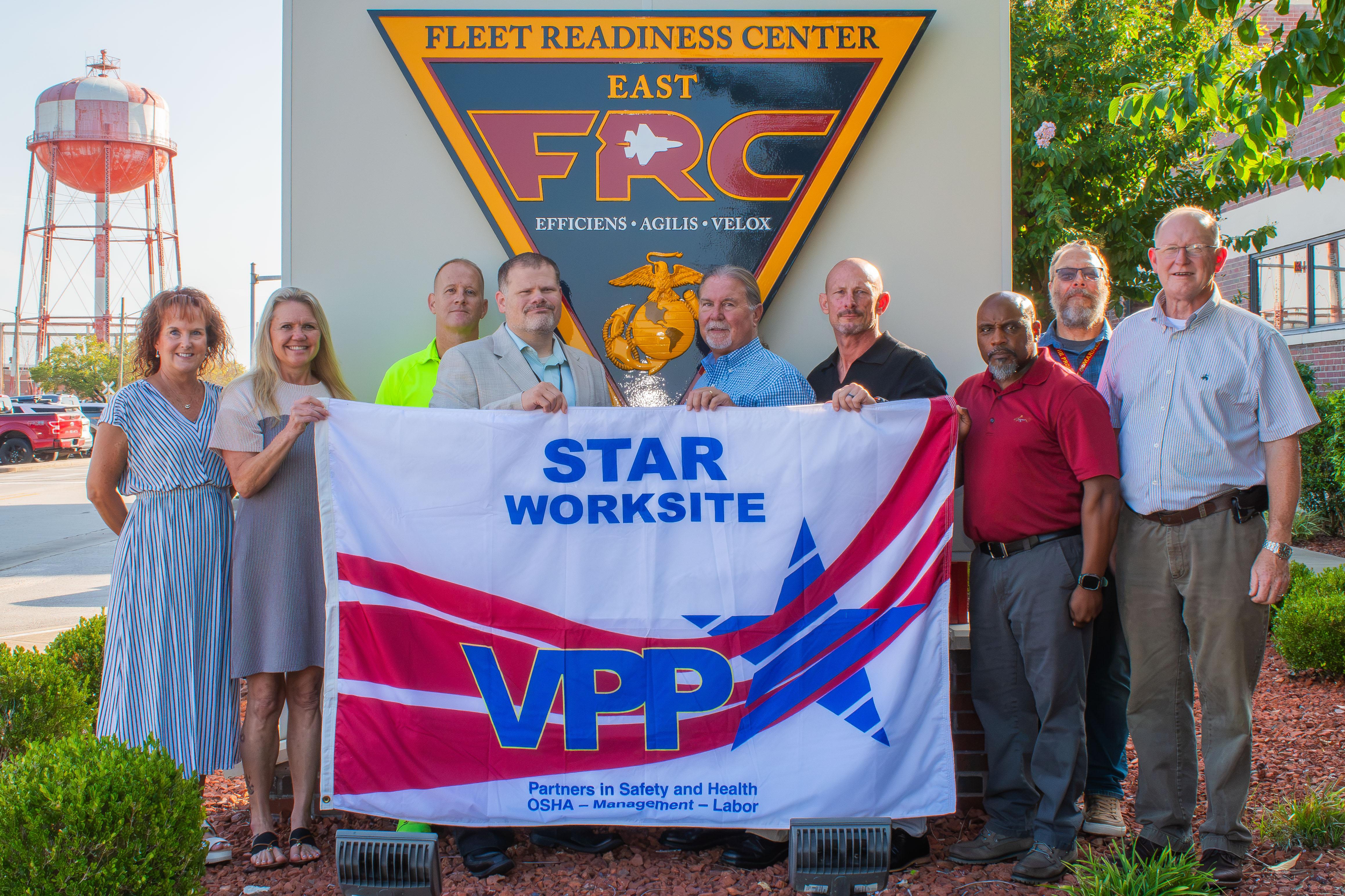  FRCE safety leaders stand with the new VPP flag.