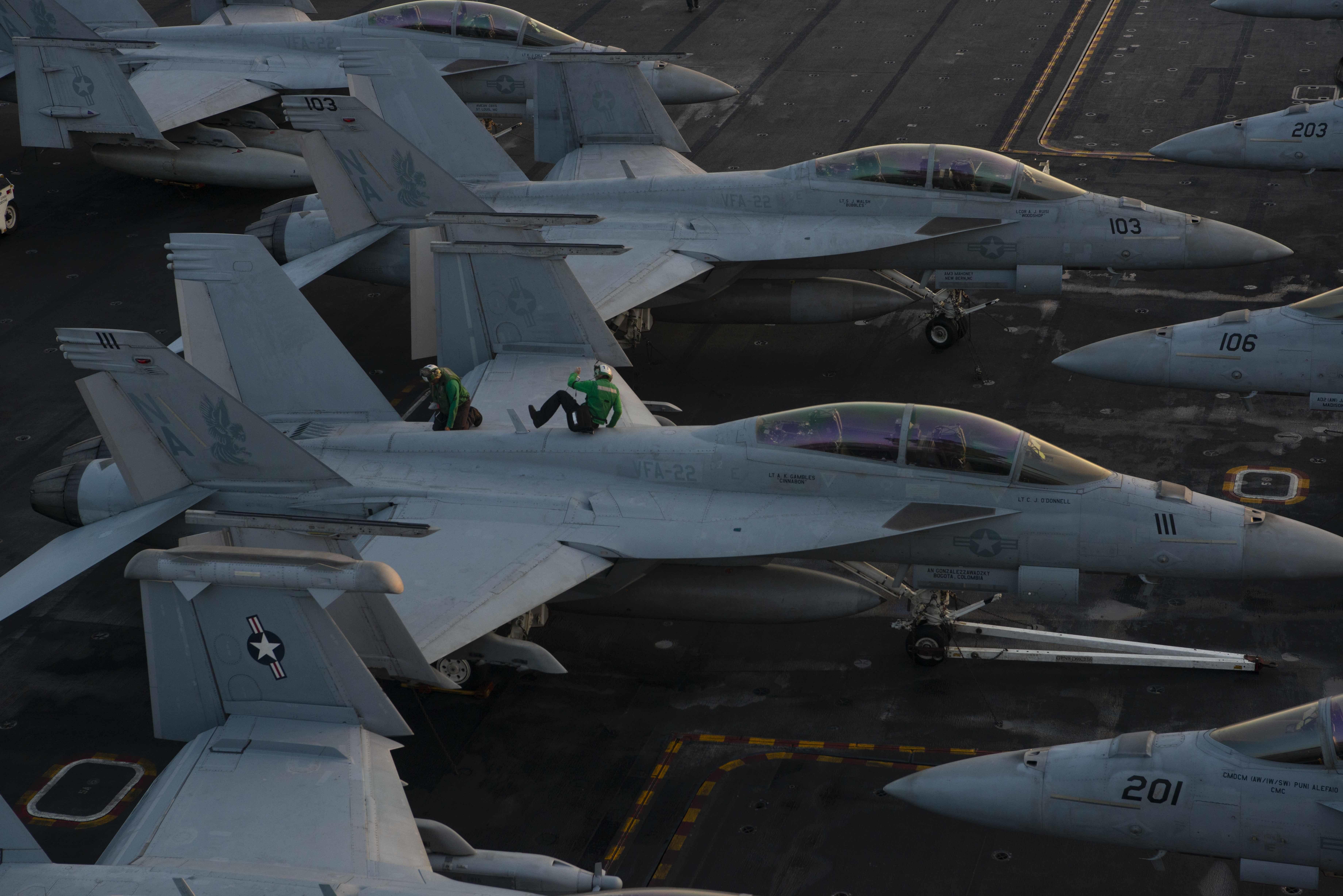 Sailors conduct maintenance on an F/A-18F Super Hornet, from the "Fighting Redcocks" of Strike Fighter Squadron (VFA-22), on the flight deck of USS Nimitz (CVN 68) 