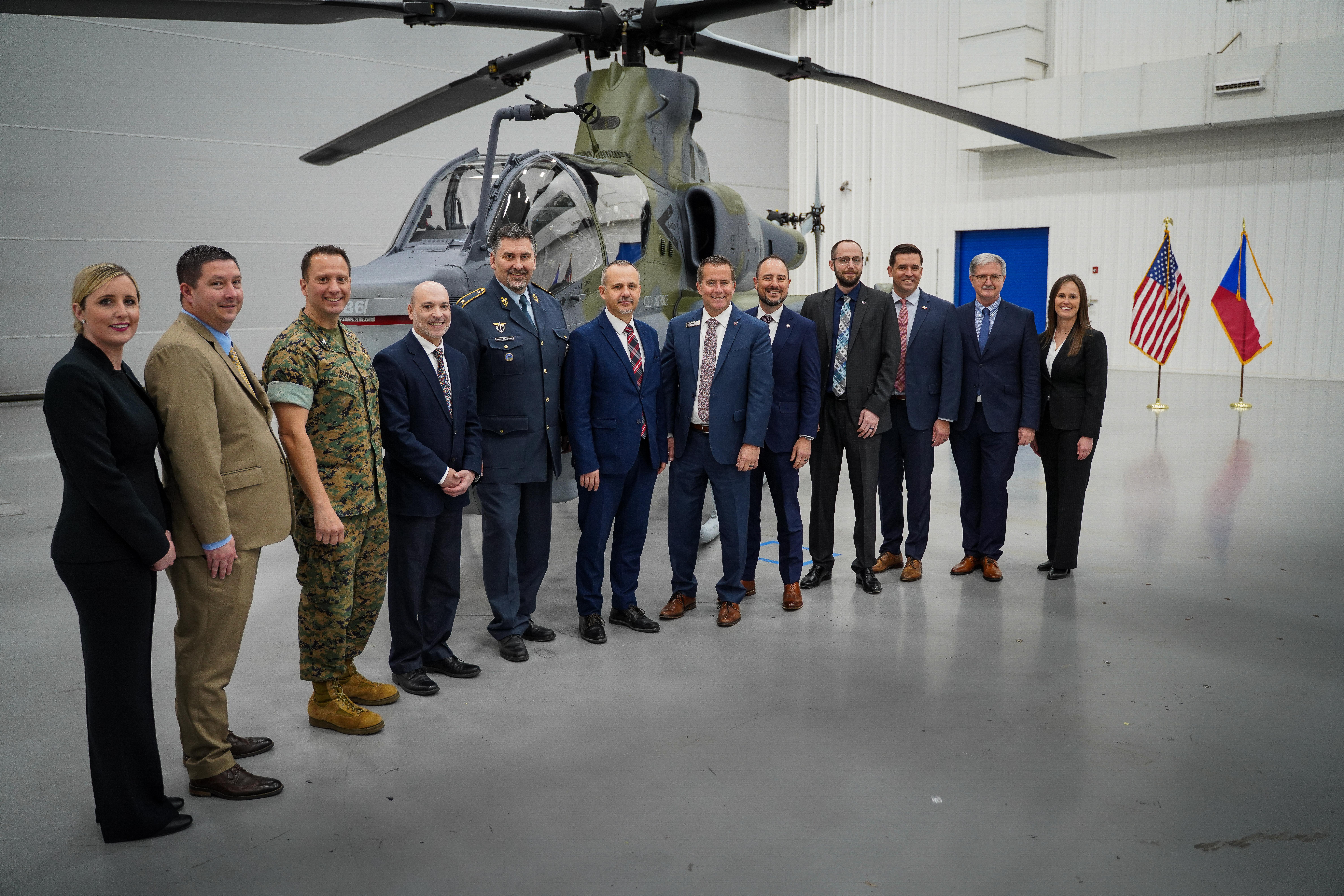Various visitors from the Czech Republic Ministry of Defense, Naval Air Systems Command and Bell Textron pose for a photo with the recently unveiled AH-1Z Viper, the first designated to the Czech Republic Air Force.