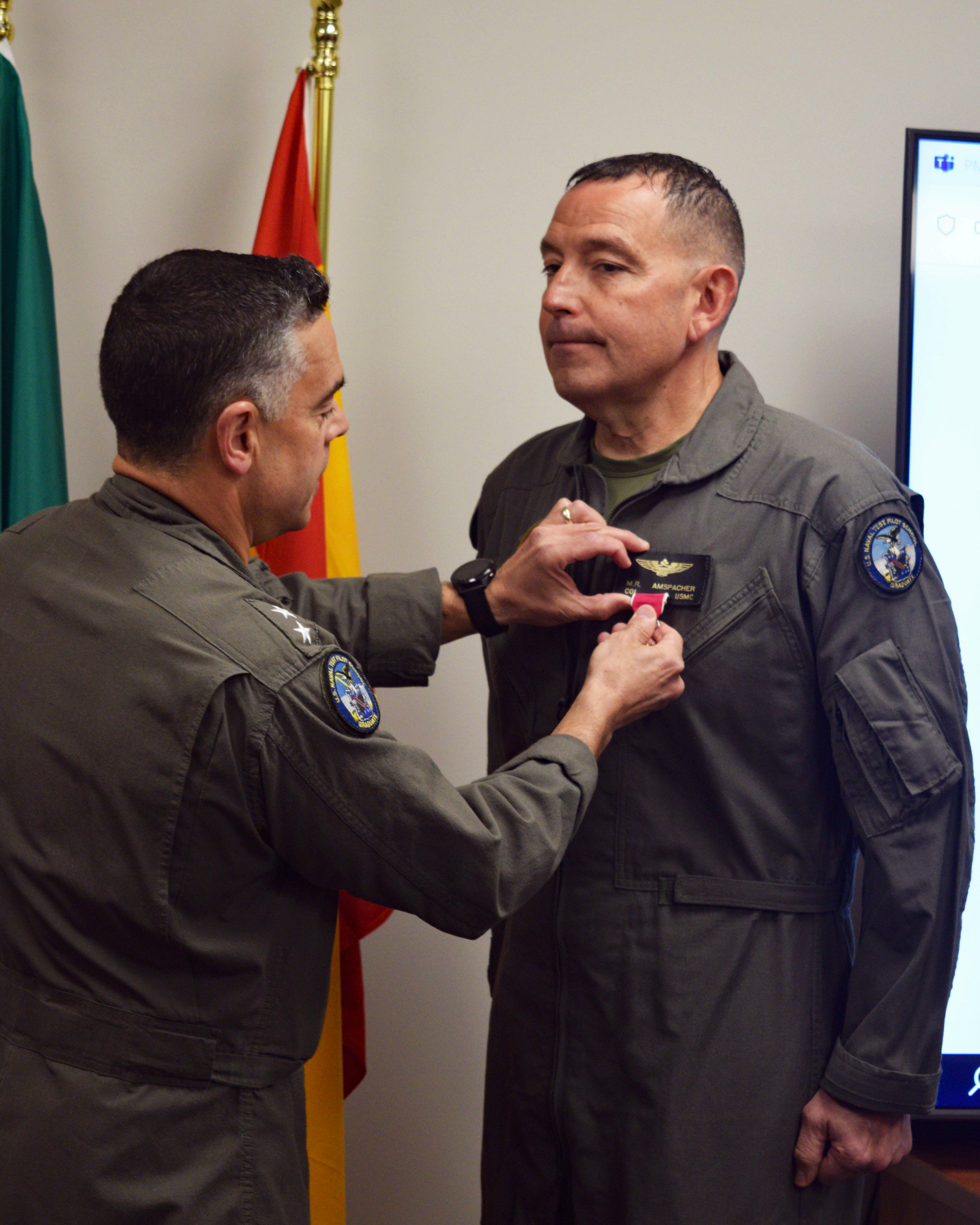 Rear Adm. John Lemmon presents a Legion of Merit award to Col. Mark Amspacher