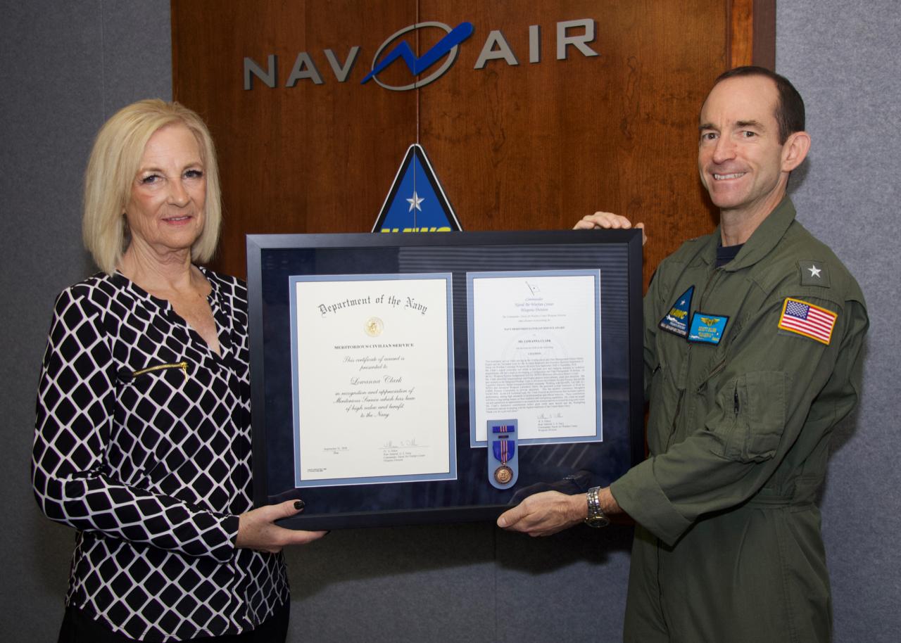 Lea Clark receives a Navy Meritorious Civilian Service Award from Rear Adm. Scott Dillon, Naval Air Warfare Center Weapons Division commander, during a Nov. 9 ceremony at China Lake. (U.S. Navy photo released)