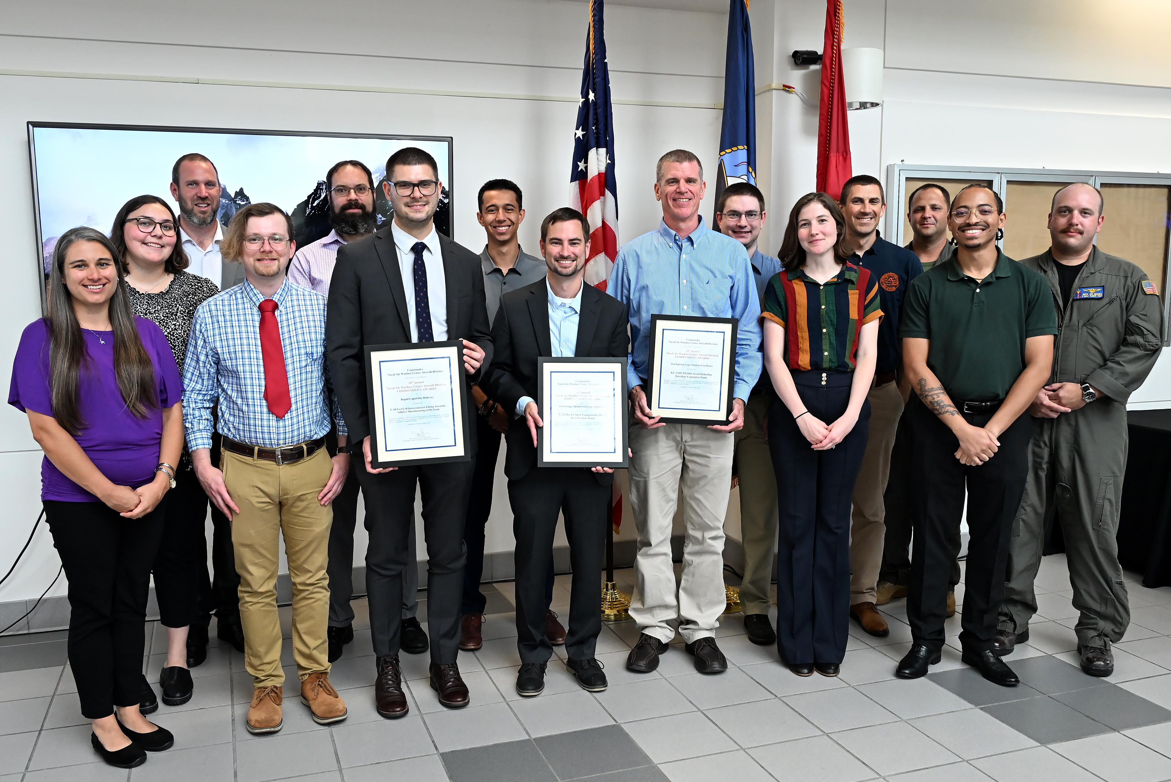 A group of professions stand with their awards 