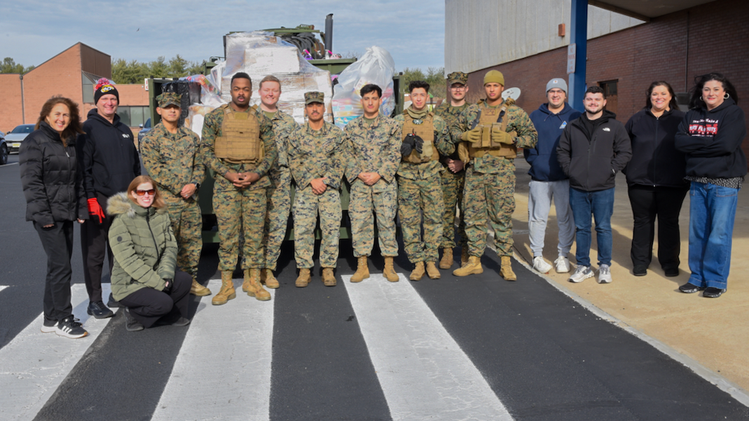 NAWCAD Lakehurst team members pose with Marines during the annual Toys for Tots drive.