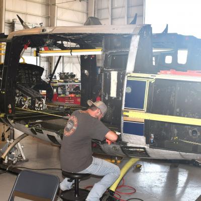 Men working on UH-1N helicopter