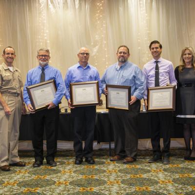 Winners of the Michelson Laboratory Award accept their certificates from Rear Adm. Scott Dillon, NAWCWD commander, and Joan Johnson, NAWCWD executive director, during the 2019 Honorary Awards Ceremony at China Lake on June 25. (U.S. Navy photo by Ryan Smith)
