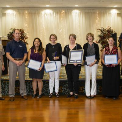 Winners of the Business Management Excellence Team Award, Let’s Go Team, accept their certificates from Rear Adm. Scott Dillon, NAWCWD commander, and Joan Johnson, NAWCWD executive director, during the 2019 Honorary Awards Ceremony at China Lake on June 25. (U.S. Navy photo by Ryan Smith)