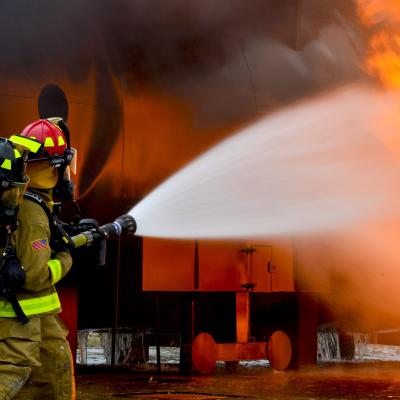 Firefighters from the 181st and the 317th Engineer Detachment spray water during an aircraft rescue and firefighting fire burn.