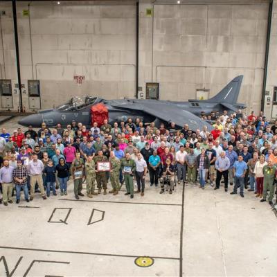 large group of people in front of AV-8B Harrier