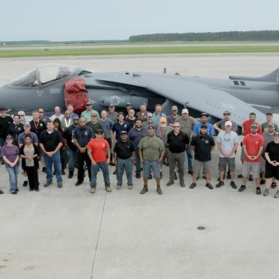 Group photo of Harrier team with final USMC jet