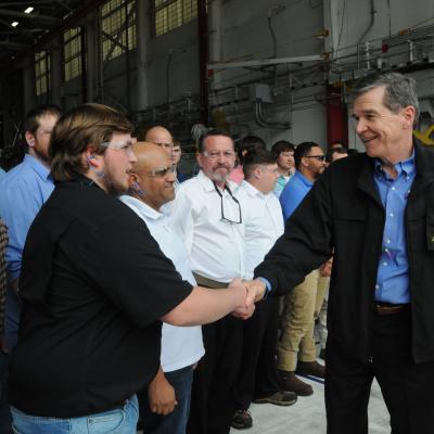 North Carolina Gov. Roy Cooper shakes hands with FRCE apprentices