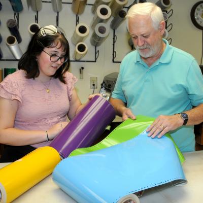 High school student considers color options in adhesive vinyl