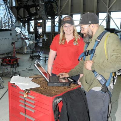 FRCE quality engineer Maddie Dunton works with aircraft mechanic Arkeith Gough