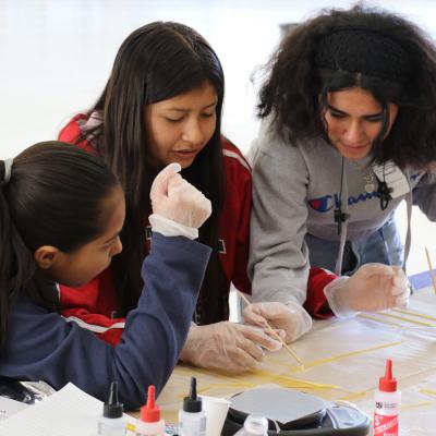 Students from Isbell Middle School in Santa Paula, California, work on their spaghetti bridges during the annual Tri-Warfare Center STEM Challenge in Point Mugu, California, on Feb. 20. (U.S. Navy photo by Kimberly Brown)