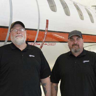 Precision Turbines, Inc., C-26 site manager Dave Wismer, left, and mechanic Zachary Timmons are responsible for maintaining the U.S. Naval Test Pilot School’s ASTARS-III Flying Classroom.