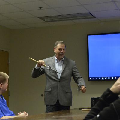 Ian Anderson, director of the Tactical Engineer Development Program at Naval Air Warfare Center Weapons Division, discusses air combat tactics with class participants at Naval Air Station Patuxent River as a way to help them better understand the operational needs of warfighters.