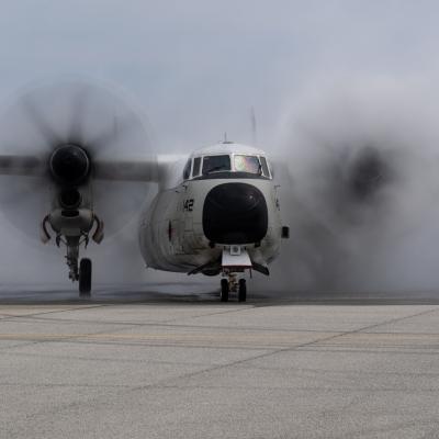 C-2A Greyhound BuNo 162142 rolls through a water cannon salute at Naval Air Station Patuxent River following its final flight on March 19, 2020. (U.S. Navy photo by Steve Wolff)