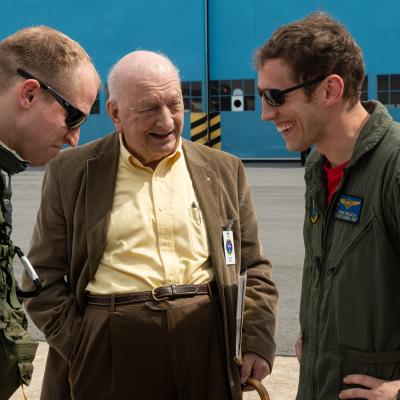 Dave Seeman, center, a retired Grumman test pilot who was one of the first to fly the C-2A Greyhound when it debuted in 1964, shares an anecdote with VX-20 test pilots LCDR Eric “Turbo” Thurber, left, and LT Paul “Digger” Deluca following the final flight of VX-20’s C-2A Greyhound, BuNo 162142 in March. Seeman was the guest of honor for the ceremony welcoming 142 home for the last time. (U.S. Navy photo by Steve Wolff)