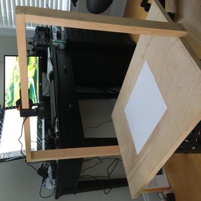 To help instruct remote students during the COVID-19 pandemic, U.S. Naval Test Pilot School instructors have rigged up ingenious alternatives to the traditional blackboard, like this overhead projection device in the home office of chief academic instructor John O'Connor.