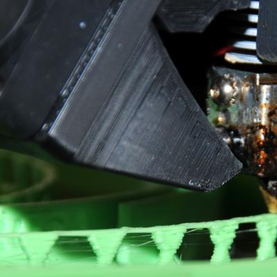 3D printer nozzle lays down layers of thermal plastic to produce a headband