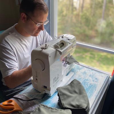 Assistant Maintenance Officer/Material Control Officer Orlando Suazo of Air Test and Evaluation Squadron (HX) 21 works the sewing machine making face masks for medical personnel, first responders, and squadron colleagues. (U.S. Navy photo by Chief Warrant Officer 2 Orlando Suazo)