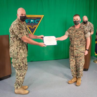 JACKSONVILLE, Fla. (May 21, 2020) Fleet Readiness Center Southeast’s (FRCSE) Commanding Officer, Col. Fred Schenk (right) presents Cmdr. Michael Polito, Officer in Charge (OIC), FRCSE Det. Jacksonville (left), with a Meritorious Service Medal during a Change of Charge ceremony. 
