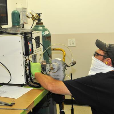 FRCE welder Robert Warmack sets up orbital welder for welding process.