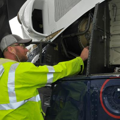 FRCE mechanic inspects H-1 helicopter before test flight.