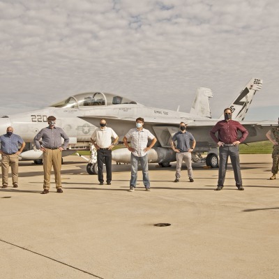 At the request of a U.S. Navy strike squadron, a team of Naval Air Warfare Center Aircraft Division F/A-18E/F aerial refueling engineers recently expedited a clearance to allow Super Hornets to use the Centerline Drogue System on Air Force KC-46A Pegasus tankers. From left to right: Seth Shaw, Jim Payne, Mike Nowotny, Tom Cavallaro, Tyler Pegg, Nick Bartlett, Chris Nickell, Maj. Daniel Johnson, and Lt. Chad “Nature Boy” Henderson. (U.S. Navy photo by Erik Hildebrandt)