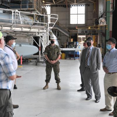 Group stands in front of H-53 helicopter