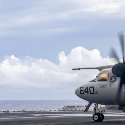 A Sailor assigned to USS Gerald R. Ford (CVN 78) signals "move back" to an E-2D Tracer.