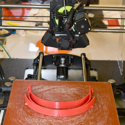 A 3D printer lays down layers of plastic to manufacture a headband