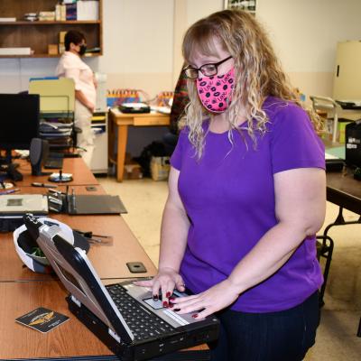 Data management specialist updates an electronic manual.