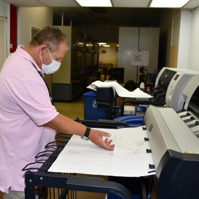 Drawing technician prints a technical drawing. 