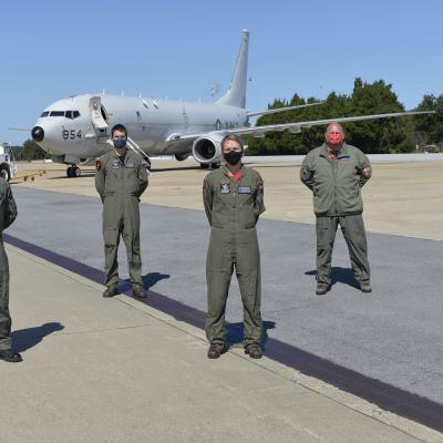 Katie Giewont, second from right, a Harpoon flight test engineer, joins the crew of "Score 42," a P-8A Poseidon assigned to Air Test and Evaluation Squadron (VX) 20, whom she guided during a recent search-and-rescue mission near Wallops Island, Va. The P-8A crew included (from left to right) Royal Australian Air Force SQNLDR Joseph Mack, AWO2 Andrew Harlan, Lt. Cmdr. Nathan Durham, Lt. Cmdr. Megan Stateler, Mr. Bryan Smith, and Lt. Christopher Sheehan. Not shown: Lt. Kevin Wunderly of Air Test and Evaluatio