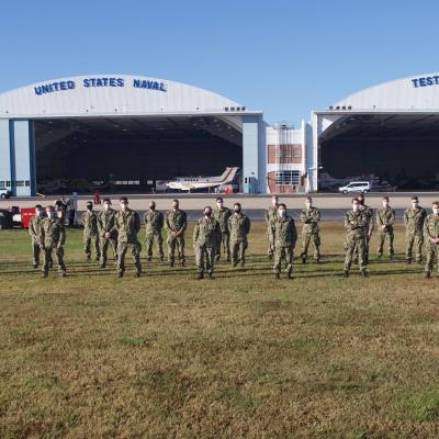 A group of aerospace engineering midshipmen from the United States Naval Academy toured Naval Test Wing Atlantic Nov. 9, 2020, an annual event sponsored by Prof. Robert Niewoehner (third from right), a former F-14 Tomcat test pilot and a graduate of the U.S. Naval Test Pilot School.
