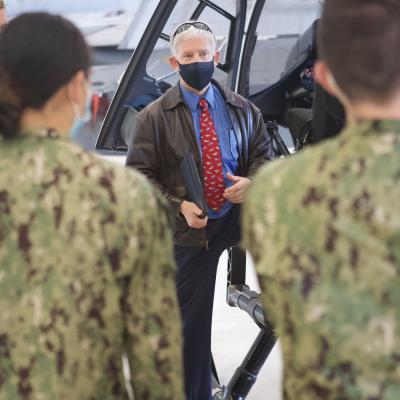 Prof. Robert Niewoehner, an aerospace engineering instructor at the United States Naval Academy, listens as midshipmen participate in a briefing on flight test aircraft at the U.S. Naval Test Pilot School during a tour Nov. 9, 2020.