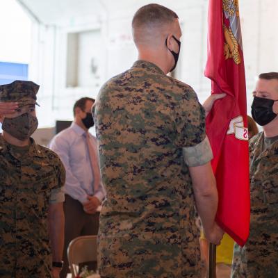 Col. Brian Taylor (left) relieves Col. Matthew Kelly (right) as the program manager of the V-22 Joint Program Office (PMA-275) during a change of command ceremony at Naval Air Station Patuxent River Apr. 29. Lt. Col. Jason Duke, master of ceremonies, salutes during the passing of the colors. 