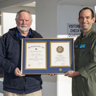 Clint Robbins poses with Rear Adm. Scott Dillon in front of the headquarters building in China Lake after receiving a 40-year length-of-service award on Jan. 6. (U.S. Navy photo by Ryan Smith)