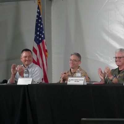 Panelists applaud during a NISE TEM panel