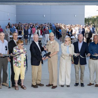 Naval Air Warfare Center Weapons Division Commander Rear Adm. Keith Hash, center right, and Alexander Rogers, Dr. Peggy Rogers’ son, center left, pose after cutting the ribbon on NAWCWD’s newest laboratory, the Dr. Marguerite “Peggy” Rogers Lab in China Lake, California, on Oct. 24. 