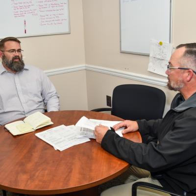 Two men sitting at a round table 