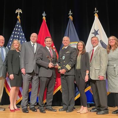Group on stage with award