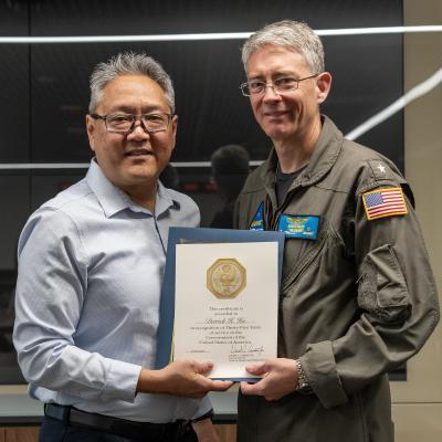 Derrick Hu, director of the Office of Small Business Programs at Naval Air Warfare Center Weapons Division, poses with Rear Adm. Keith Hash, commander of Naval Air Warfare Center Weapons Division, after receiving his 35-year Length of Service award during a ceremony in China Lake, California. Hu’s career spans multiple roles and demonstrates unwavering dedication to supporting small businesses and the warfighter. (U.S. Navy photo by Ryan Smith)