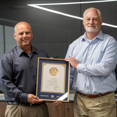 Naval Air Warfare Center Weapons Division Director for Energetics Scott Fuller (right) poses with Executive Director Dan Carreño during a ceremony in China Lake on June 4 honoring Fuller for 40 years of service to the government. (U.S. Navy photo by Ryan Smith)