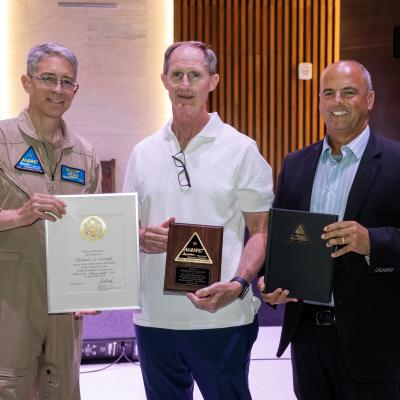 Naval Air Warfare Center Weapons Division Commander Rear Adm. Keith Hash (left) and Executive Director Dan Carreño honor Richard Cracraft for 38 years of service with the government during a retirement celebration July 10 in China Lake, Calif. Cracraft served as director of the Human Capital Management Group at NAWCWD for the past 23 years. 